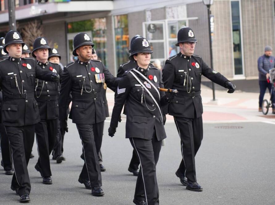Canadian police officers marching in formal uniform during a ceremonial parade