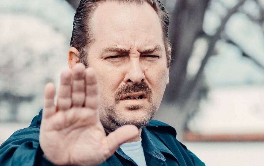 CBSA inland enforcement officer raising a hand to signal stop during an enforcement operation
