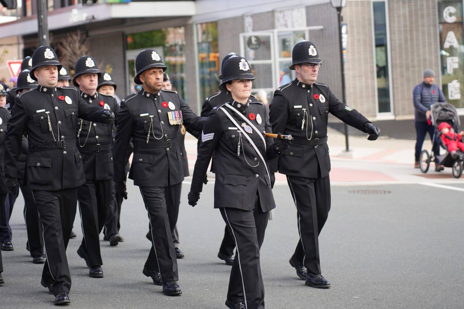 Canadian police officers marching in formal uniform during a ceremonial parade